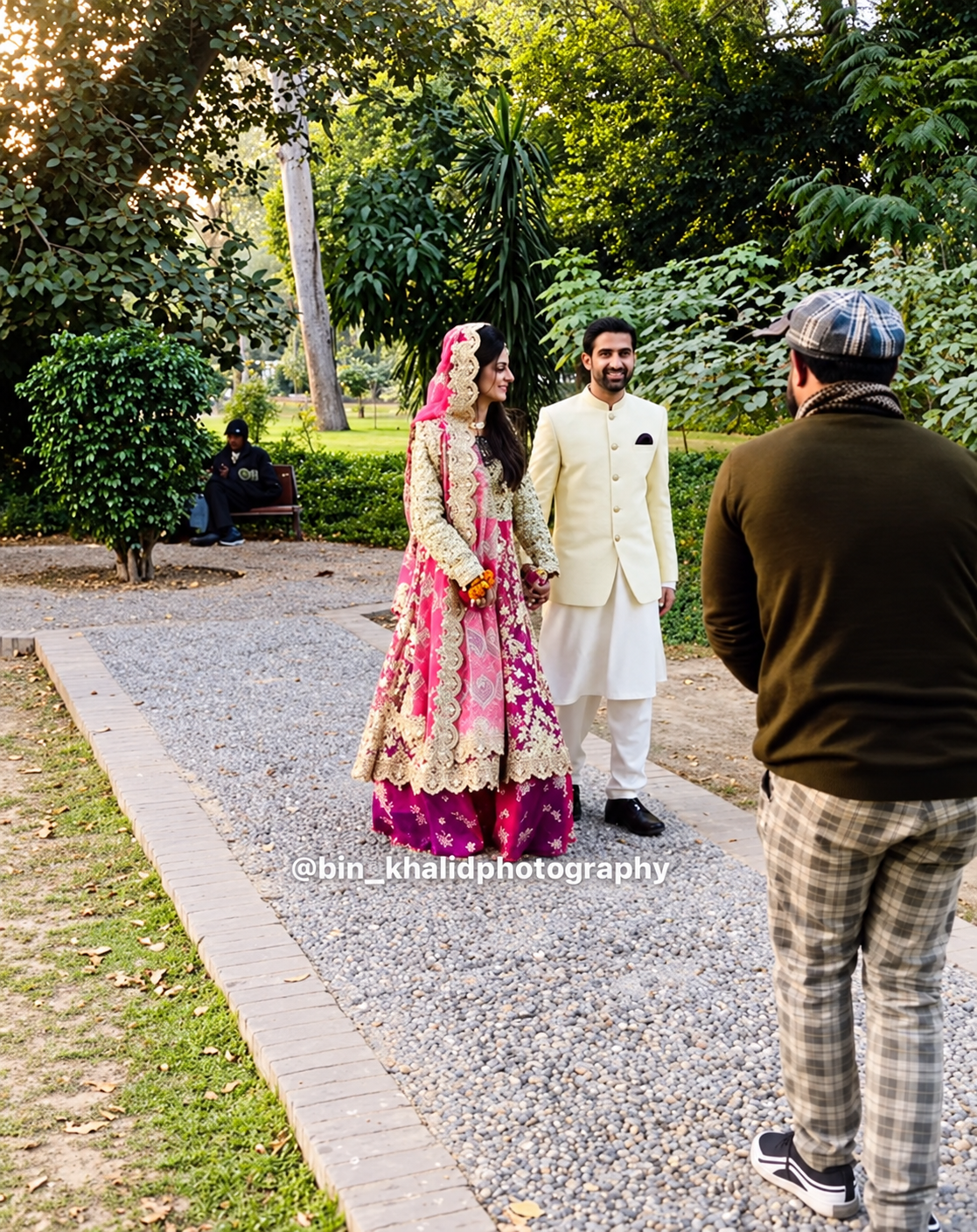 Photographer capturing a couple in a garden