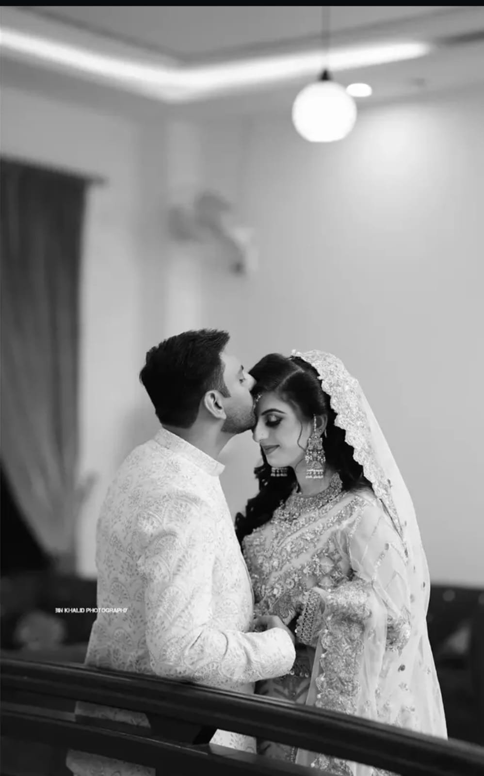 Photographer capturing a bride and groom in a wedding courtyard